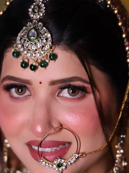 A close-up of a bridal eye look, showcasing the soft, shimmery eyeshadow and perfectly defined brows that frame the face.
