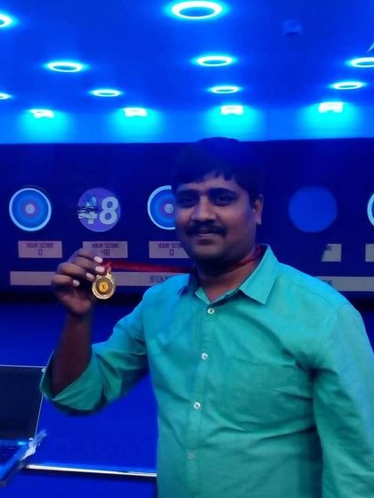 This archer proudly displays his gold medal. Our competitions and achievement awards are a great way to challenge yourself and track your improvement.