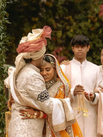 A heartfelt, candid embrace between the bride and groom. It's these unposed, emotional moments that I believe truly tell the story of your love.