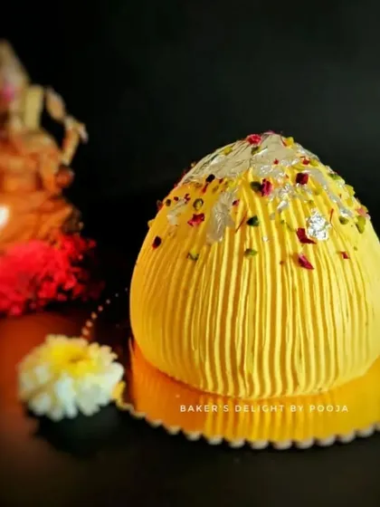 A Modak-shaped cake for Ganesh Chaturthi. This eggless cake is my tribute to the festival, shaped like Lord Ganesha's favorite sweet and decorated with edible silver leaf and rose petals.