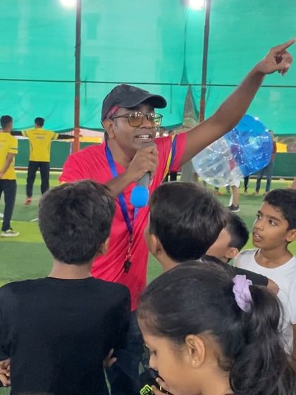 Our head coach rallying the troops. With a microphone in hand, he gets everyone excited and ready for the next big challenge, ensuring the energy never drops.