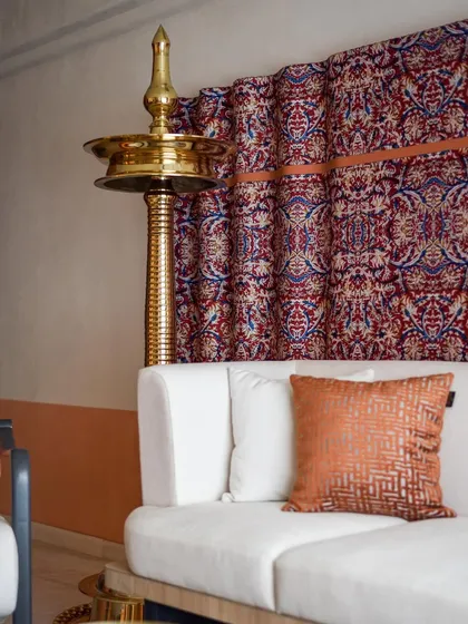The stunning "Kalamkari fabric art piece" is the focal point of the living room. We chose light-colored furniture to allow the strong visuals of the fabric to stand out.
