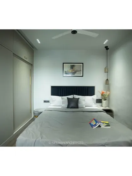 The master bedroom at Tulsi Heights is a study in calm. The simple color palette, clean lines of the wardrobe, and soft lighting create a space that feels like a deep, relaxing slumber.