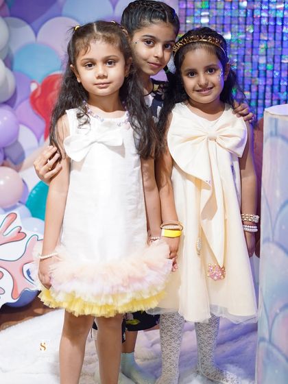 Three adorable little guests dressed up for a party, ready to enjoy the magical experiences we have to offer.