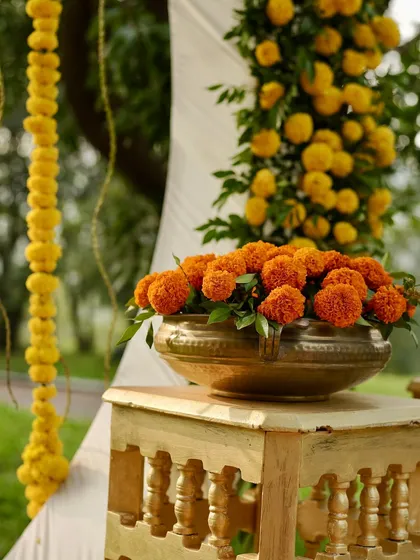 A closer view of the traditional brass urli filled with fresh orange marigolds. This element is a staple in Indian festival decor, bringing both color and a sense of heritage to the celebration.