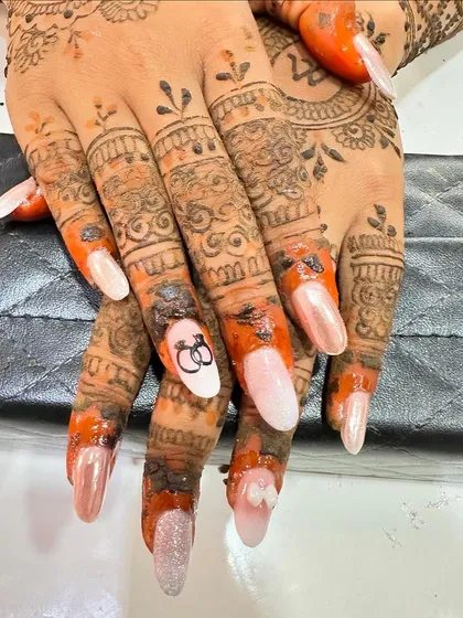 Here is the engagement nail art shown with the client's beautiful mehndi. The pearly finish of the nails provides a lovely contrast to the rich color of the henna.