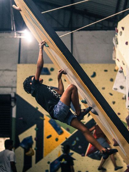 Even beginners get to tackle interesting challenges like this slight overhang. Our route setters design problems that are accessible but help you develop real climbing skills from day one.