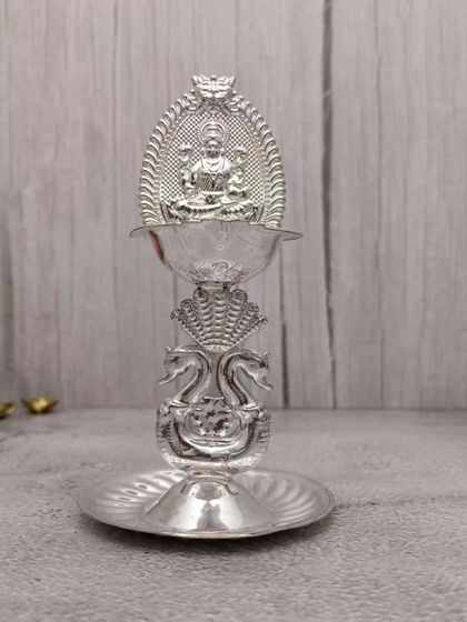 A single Hamsa Lakshmi stand diya, showing the fine detailing on the swan and the arch behind the goddess.