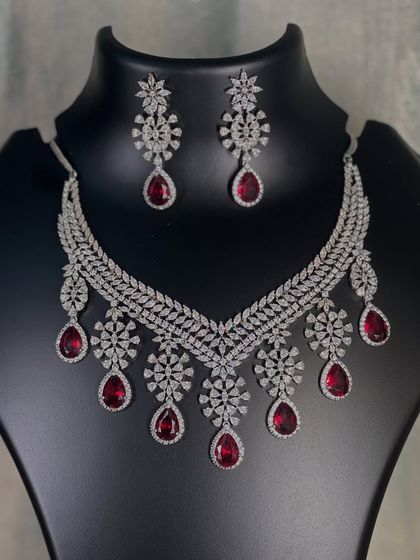 A clear photo of the V-shaped ruby and diamond necklace. This design is very flattering and a great rental option for a sophisticated party look.