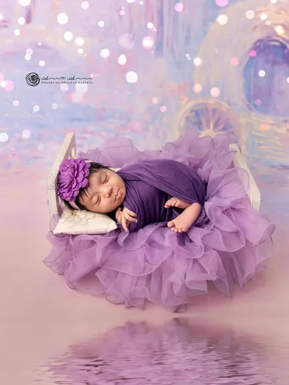 Adding a touch of digital magic. The reflection and bokeh lights enhance the dreamy quality of this lavender themed newborn portrait.