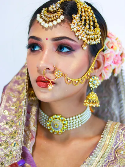 A close-up of the intricate details of this bridal look, from the winged eyeliner to the traditional nath.