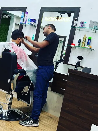 A stylist at work, focused on delivering a precision haircut. Every client gets our full attention and expertise.