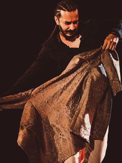 A dramatic pose with a brocade jacket during a performance at NCPA, Mumbai.