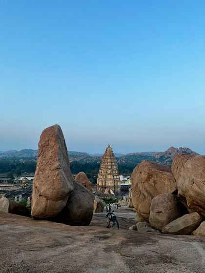 The Virupaksha Temple in Hampi, viewed from atop Hemakuta Hill. The giant boulders and sacred architecture of this land have witnessed sages and yogis practicing tapasya (austerities) for millennia.