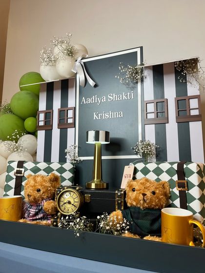 A close-up of the two well-dressed teddy bears sitting amongst the gifts.