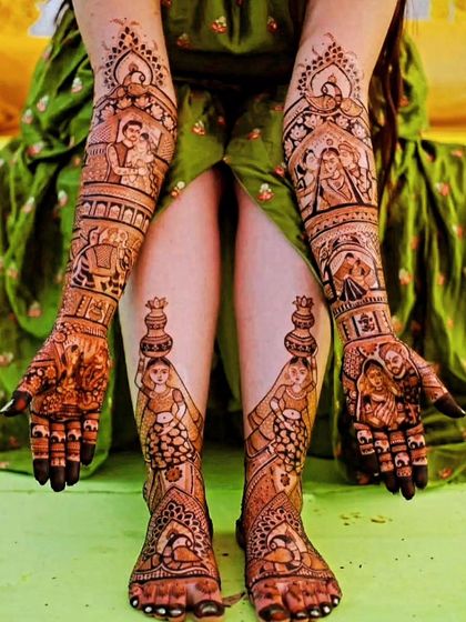 A complete bridal look from hands to feet. The arms tell a story with couple portraits, while the feet feature beautiful figures of women carrying a kalash.