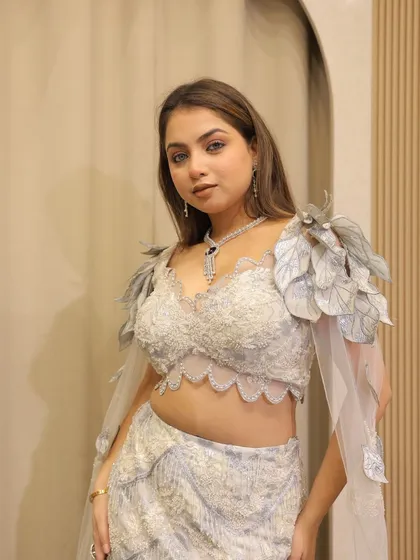 Keeping up with the trends with this fish-cut lehenga featuring unique leaf-like shoulder details. A perfect blend of nature-inspired design and modern glamour.