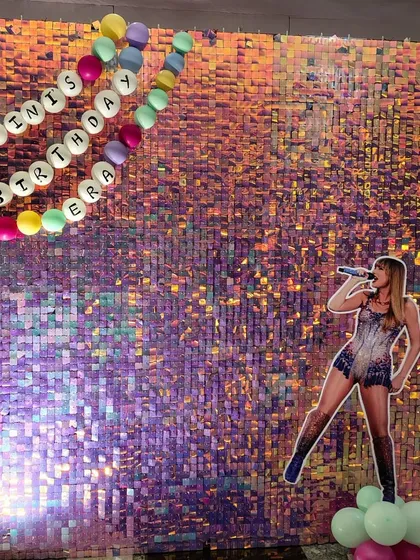 Get ready to shine with this pop star "Birthday Era" theme. We used a stunning iridescent shimmer wall as the backdrop, complete with a cutout of a pop superstar and a custom balloon banner, making the birthday girl feel like she's on center stage.