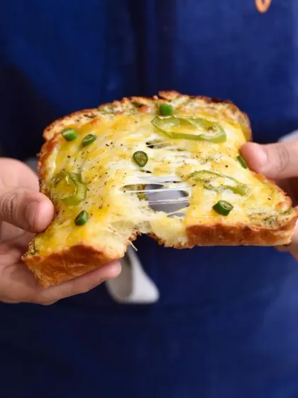This is our take on a Bombay classic, the Chilli Cheese Toast. We use our fluffy brioche, load it with cheese and green chillies, and bake it until it's golden and gooey. That cheese pull is everything you've dreamed of.