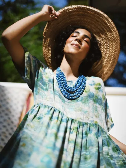 A sun-kissed portrait for House of Wandering Silk. The model's joyful expression and the warm light perfectly capture the feeling of a perfect summer day.
