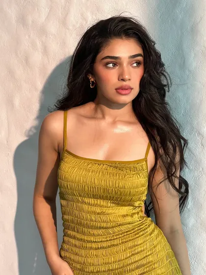 A behind-the-scenes shot of Krithi Shetty in this simple yet chic yellow summer dress. This shows that sometimes, a great fit and a pop of color are all you need.