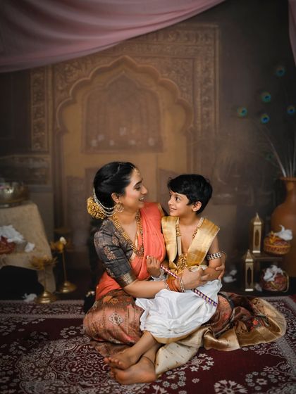 A quiet moment of connection. The elaborate set design and authentic costumes create a powerful and memorable cultural portrait.