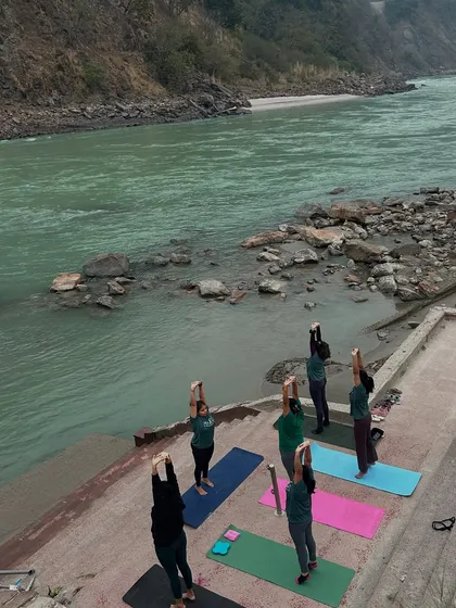 From a bird's eye view, our tribe salutes the sun on the banks of the holy Ganga. Practicing yoga in Rishikesh, surrounded by the tranquil sounds of the river and fresh mountain air, is an experience that rejuvenates the body and soul.