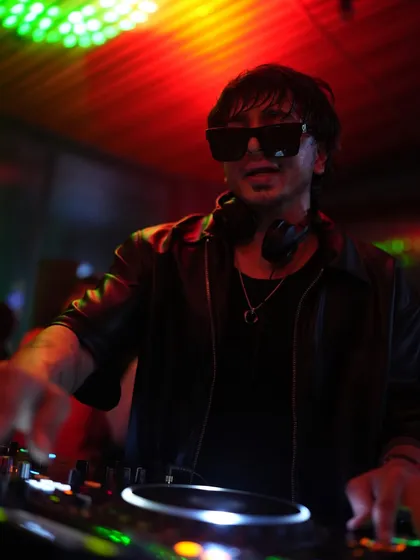 A candid shot of me at the console, bathed in colorful club lights. This captures the authentic, in-the-moment vibe of a live performance.