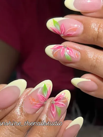 A closer look at the hand-painted flowers on this French manicure.