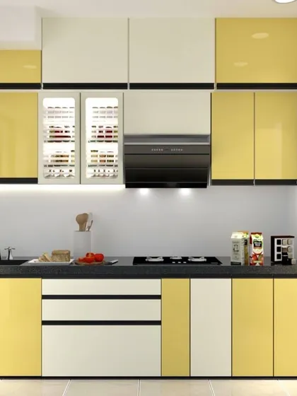 A straight-line modular kitchen in a cheerful yellow and white combination. The design includes specialized spice rack pull-outs with glass fronts for easy visibility.
