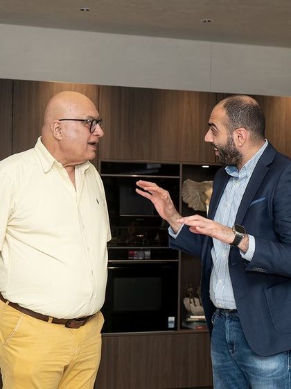 Our founder in conversation with a partner, discussing the future of kitchen design and our continued commitment to excellence.
