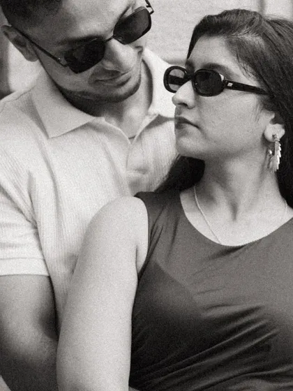 A candid black and white shot of Alicia and Jeff. The way they are looking at each other in this moment feels authentic and unposed, capturing a real piece of their dynamic.