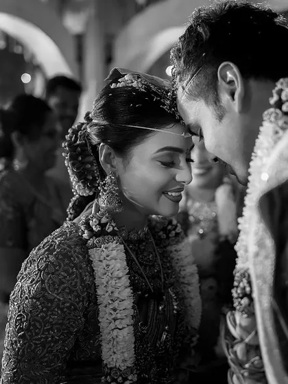An intimate, black and white moment between the bride and groom during the mangalyam ceremony. I focus on these fleeting glances and gentle touches that hold so much emotion.