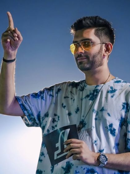 A stylized shot of me pointing upwards, directing the audience's attention to the drones in the air during the racing league.