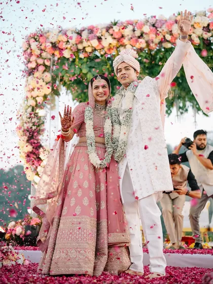 The moment it becomes real. We orchestrate these climactic moments of pure celebration, like this explosion of joy and petals, so you can simply live in the magic of being husband and wife.