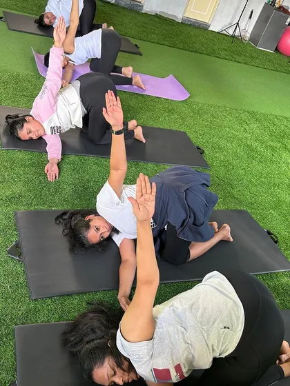 More from our International Yoga Day celebration, with members holding a synchronized twisting pose.