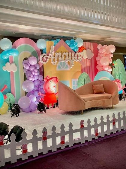 The Peppa Pig stage seen from a different angle, highlighting the pastel color scheme and the cute, cartoonish props.