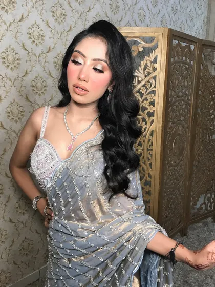 The full look, with a shimmery grey saree, is perfect for a sophisticated evening event.