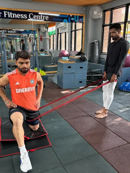 A closer look at a hands-on coaching moment with Rinku Singh. I'm providing tactile cues during a mobility drill to ensure he gets the most out of the exercise and performs it safely.