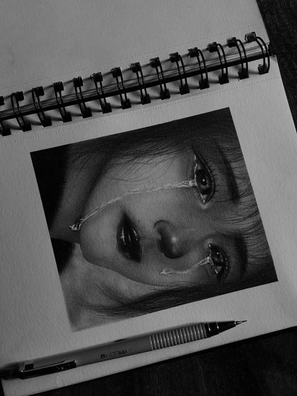 This hyper-realistic sketch of a girl's sorrowful expression is one of my most emotional pieces. I used fine pencils and blending stumps to create the realistic tears and the depth in her eyes.