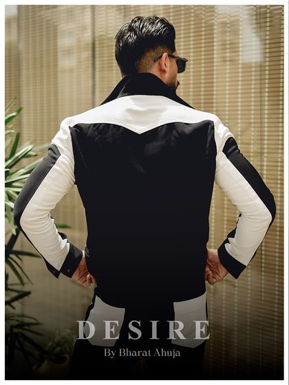 The back view of the black and white jacket, showcasing the unique western-style yoke and the continuation of the bold color-blocking.