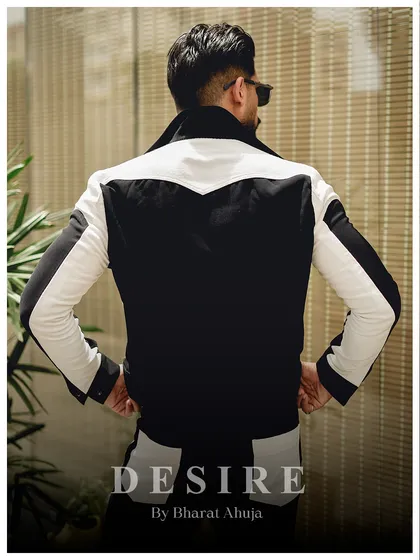 The back view of the black and white jacket, showcasing the unique western-style yoke and the continuation of the bold color-blocking.