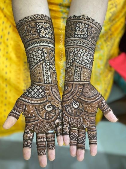 A gorgeous example of a full coverage Indian bridal design, filled with peacocks, paisleys, and delicate check patterns.