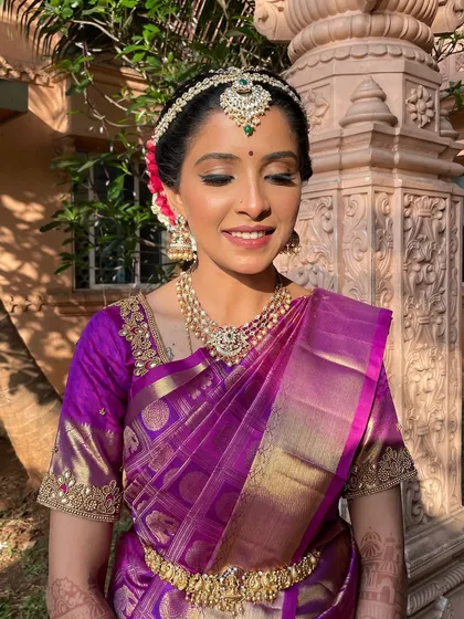 A close-up with eyes gently closed, showing the soft shimmer on the eyelids and the flawless skin. This look is all about understated elegance for the main wedding ceremony.