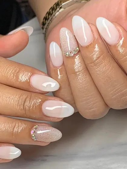 A soft and elegant ombre with a glitter accent nail and rhinestone details. This is a perfect bridal or special occasion look.