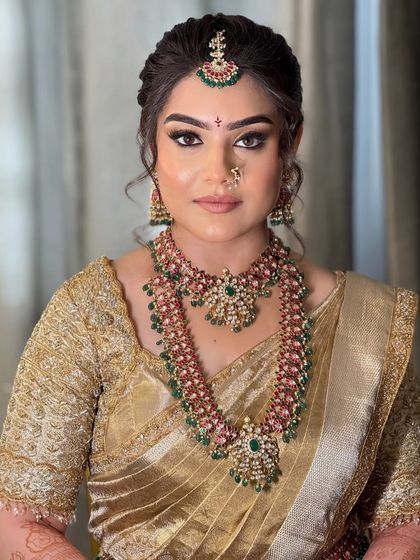 A direct portrait showing the symmetry and precision of the makeup application, from the perfectly defined brows to the balanced contour.