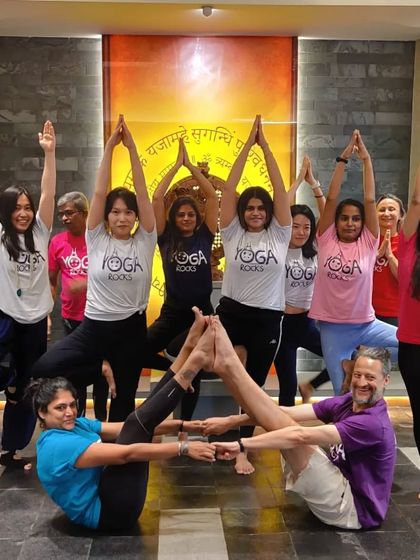 A fun and creative group Acro Yoga pose. We love finding new ways to connect and build together as a community.