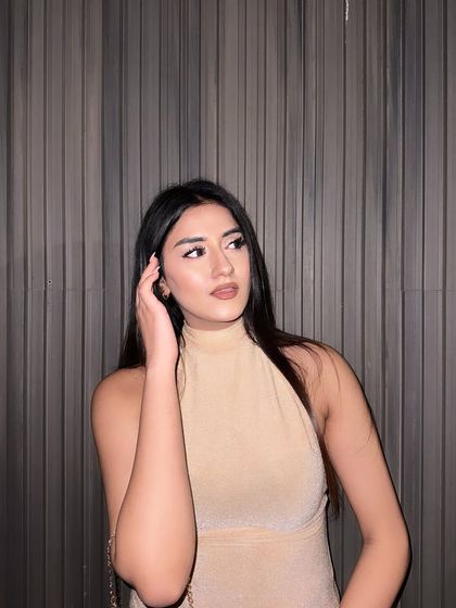 "Covered in grace." A glamorous look in a shimmery, high-neck beige gown.