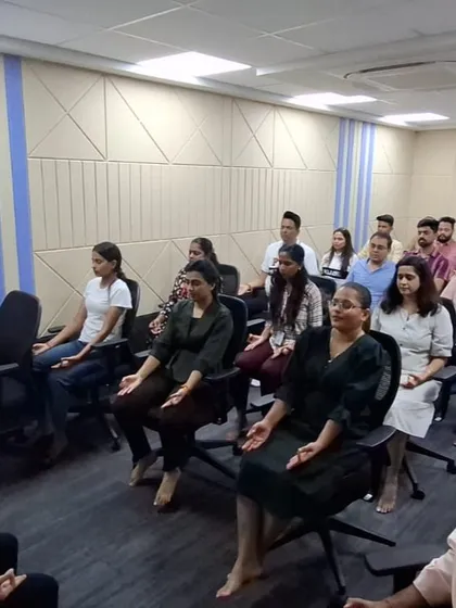 An instructor guides a meditation session for employees. Learning to quiet the mind, even for a few minutes, is a powerful skill that enhances focus and decision-making in a corporate environment.