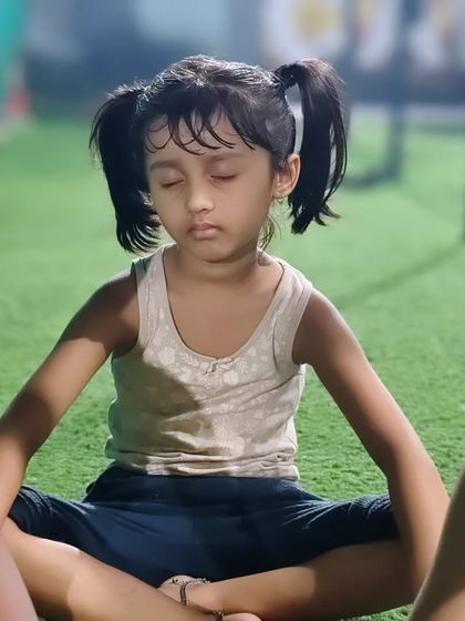 A young athlete finds her center during a meditation session. We incorporate these quiet moments to teach focus and self-awareness.